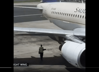 Guy walks behind a running Airbus A320 engine
