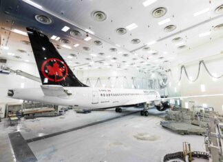 The first Airbus A220 for Air Canada rolls out of the painting hangar